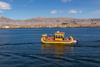 yellow and brown boat on sea during daytime