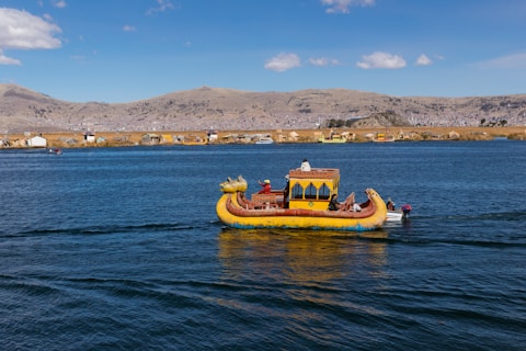 yellow and brown boat on sea during daytime