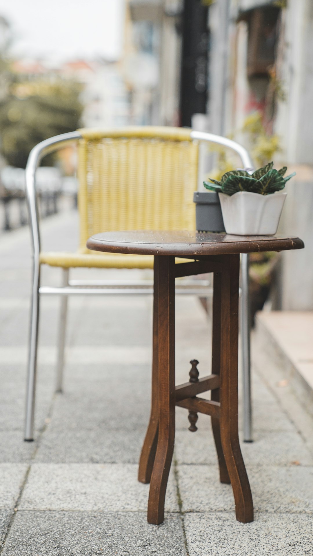 brown wooden table with green plant on top