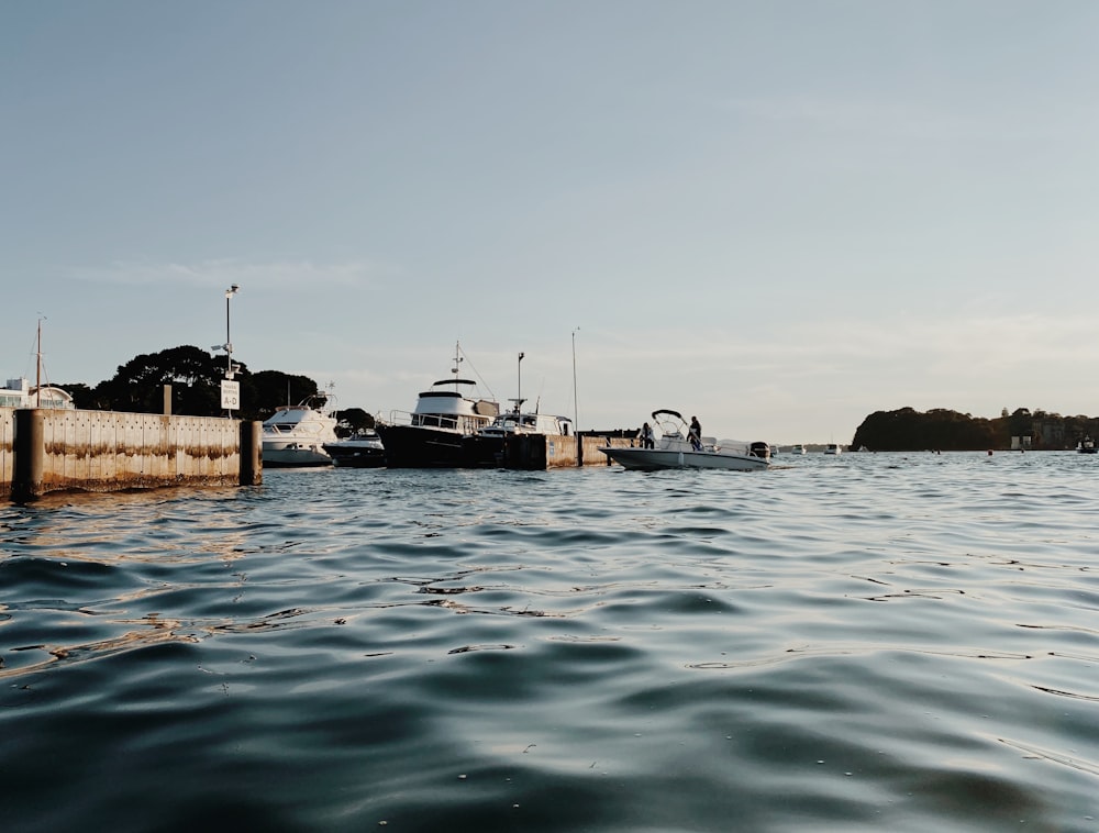 white boat on body of water during daytime