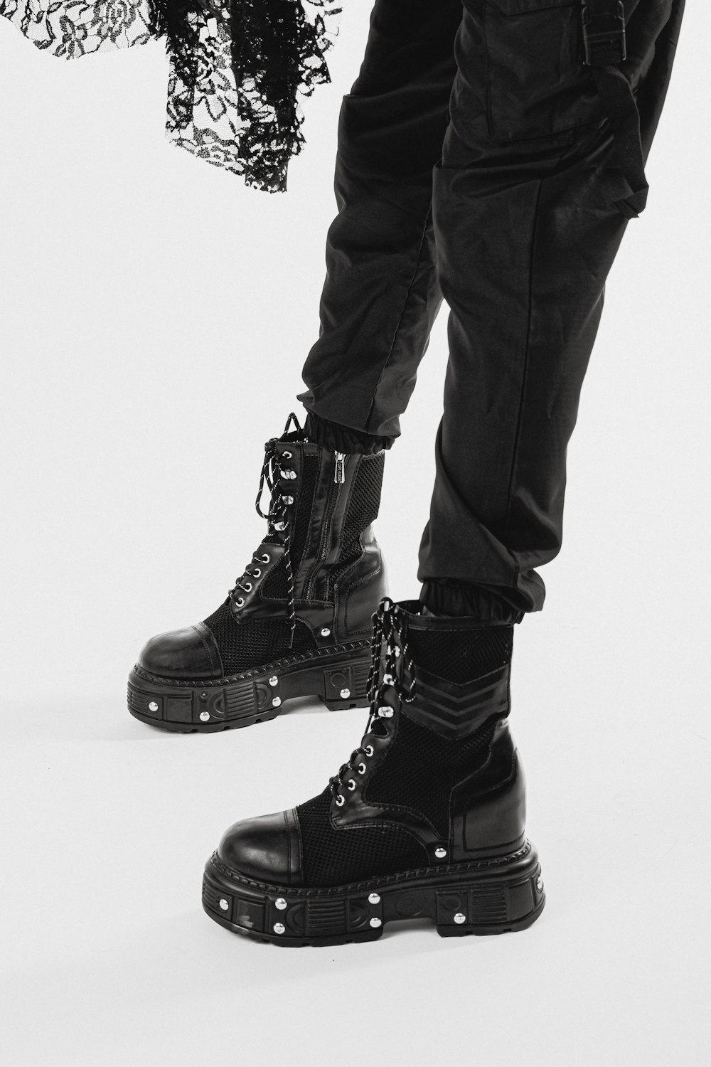 person wearing black leather boots