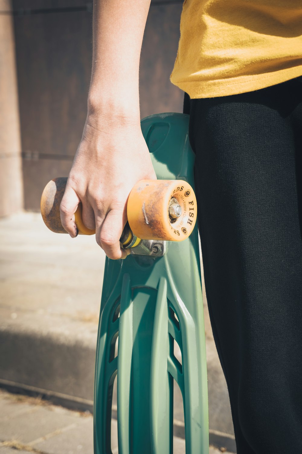 person holding brown wooden round ornament