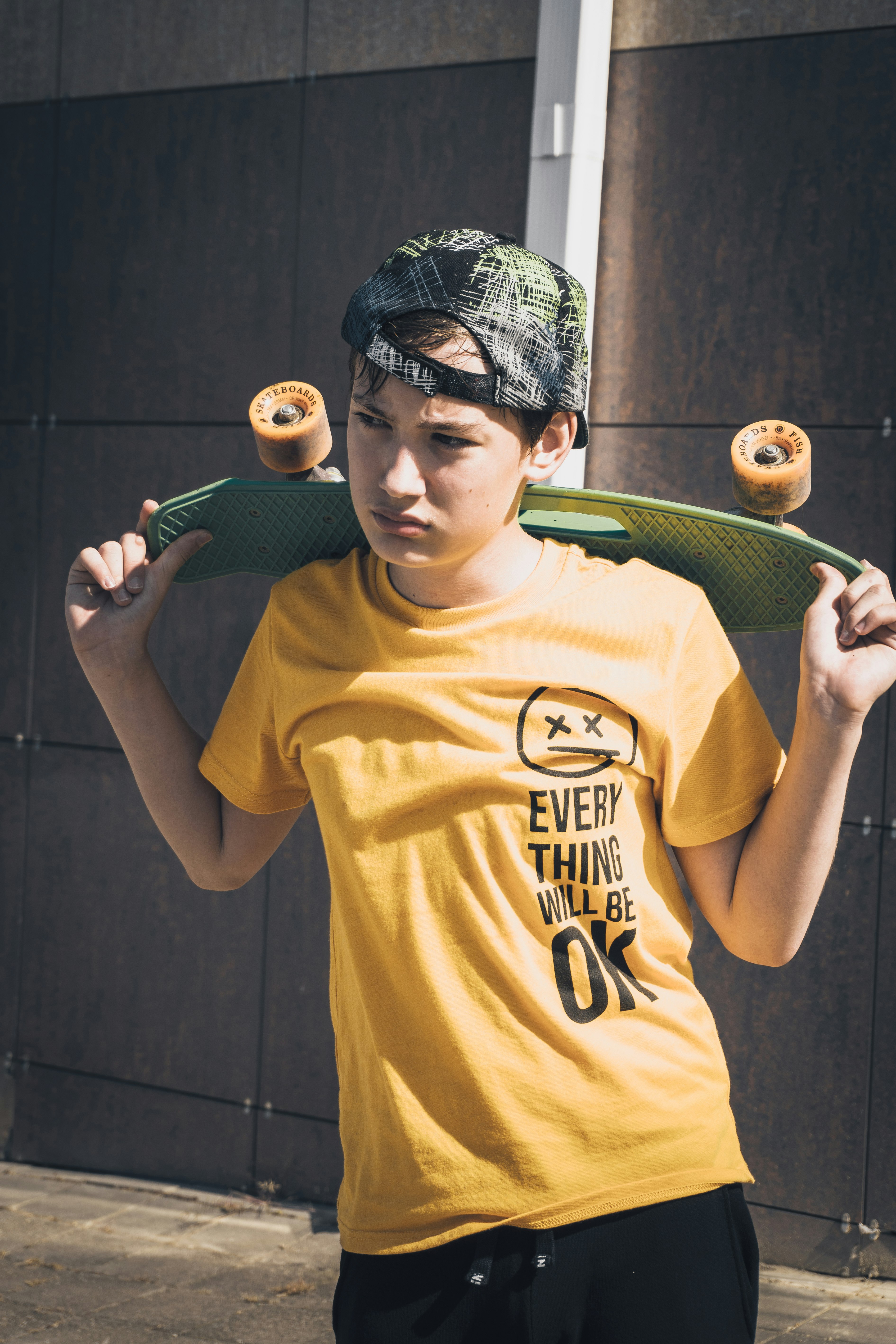 man in yellow crew neck t-shirt holding green tennis racket