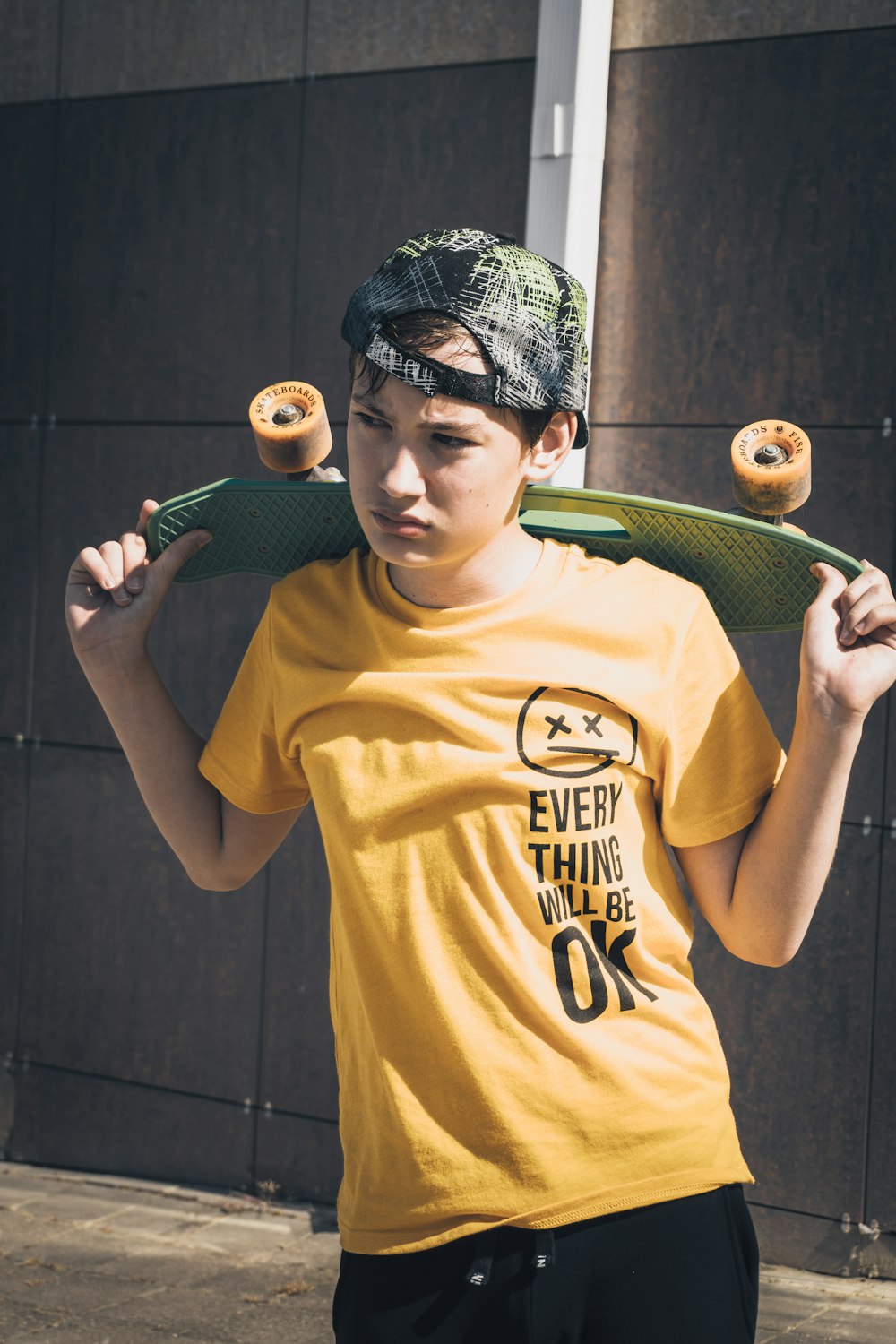 man in yellow crew neck t-shirt holding green tennis racket