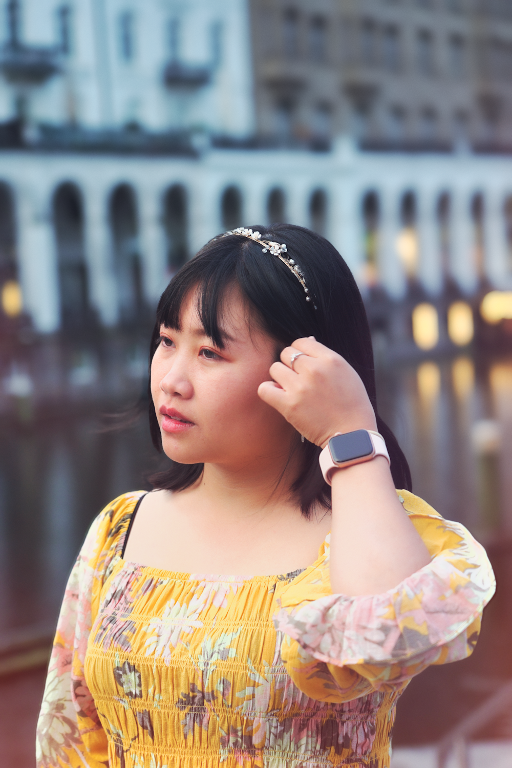 woman in yellow and white floral dress wearing white and gold watch