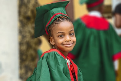 A child studying happily with books and a graduation cap symbolizing education insurance.