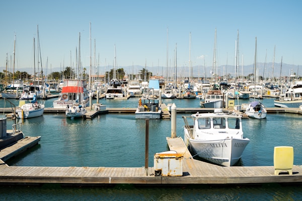 white and brown boat on dock during daytimeby Mike Kitchen