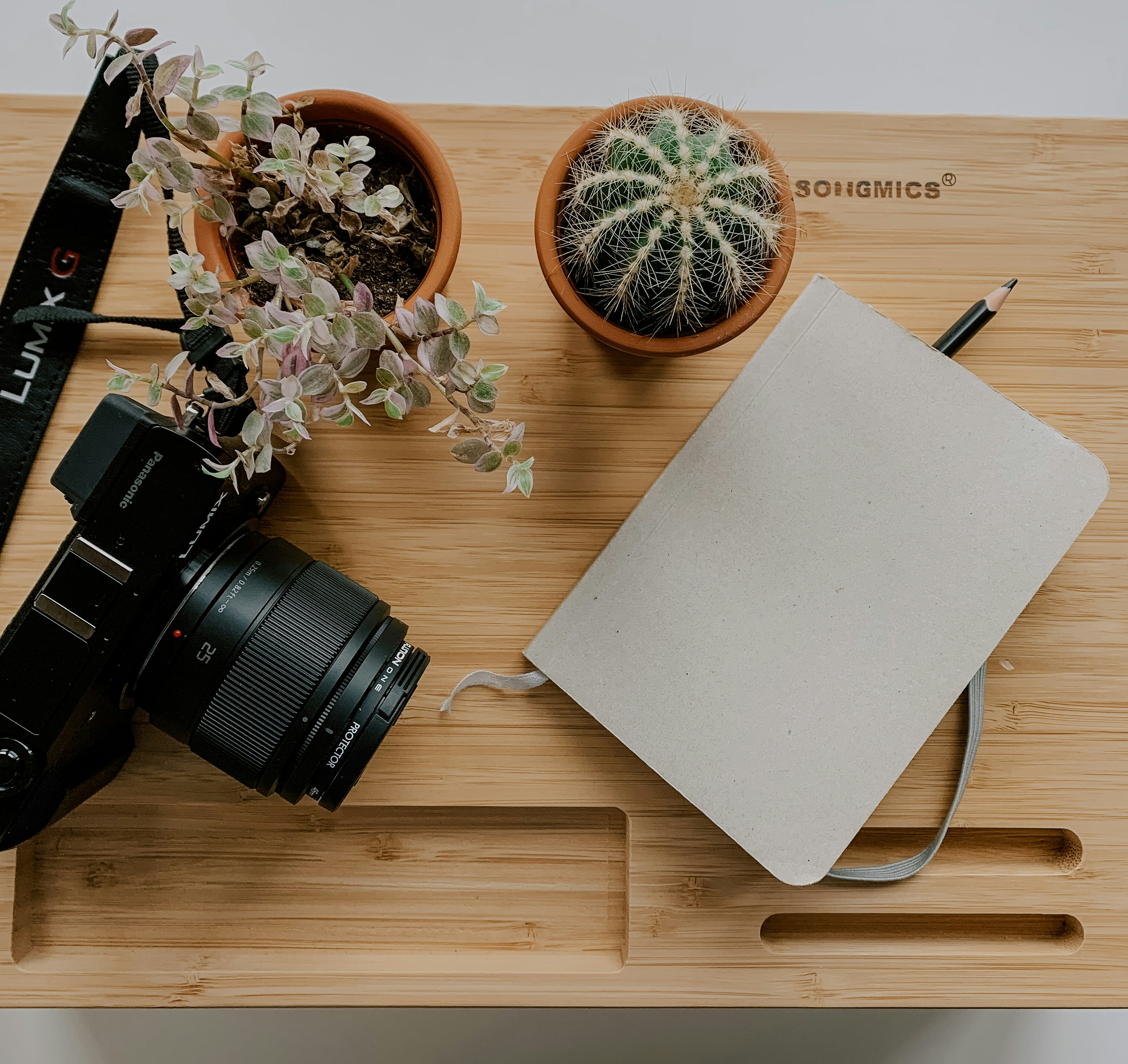 black dslr camera on brown wooden table