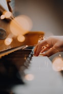 person playing piano in close up photography