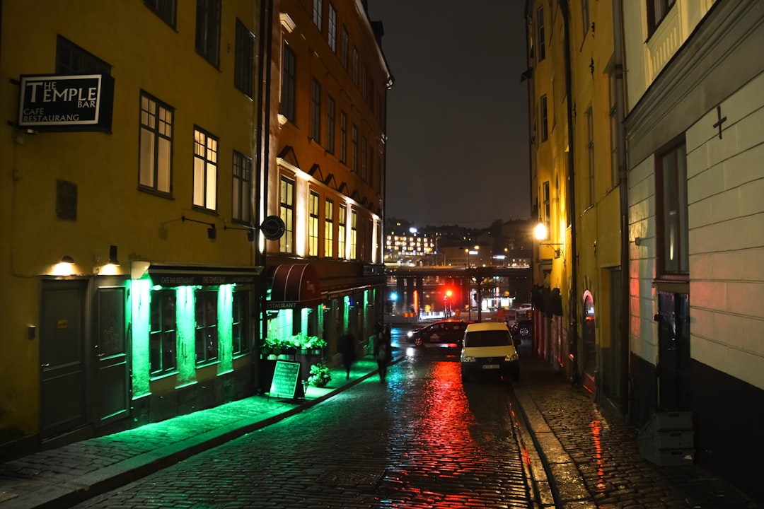 red and black boat on the street during night time