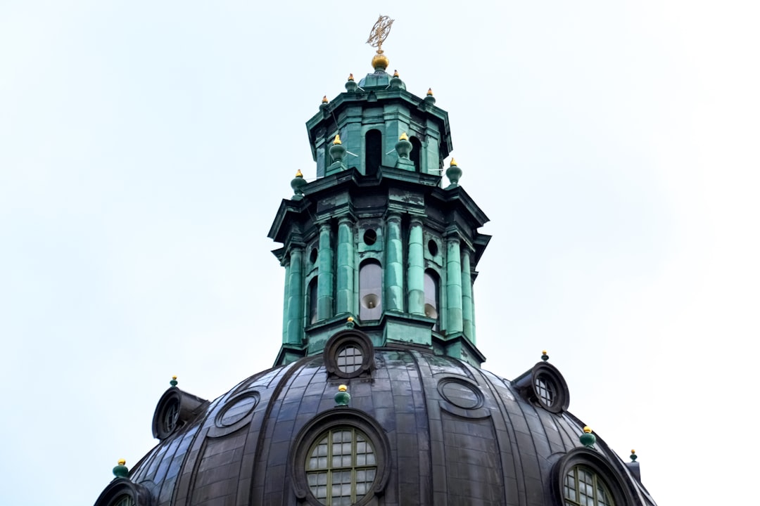 green concrete building under white sky during daytime