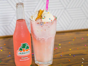 Close-up of a colorful dirty soda topped with whipped cream and a straw, styled with retro desert colors.