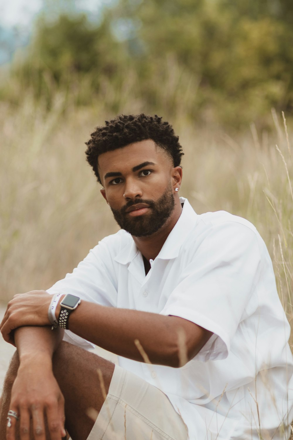 man in white polo shirt wearing white watch