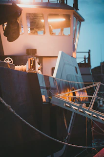 Close-up of high-tech sonar equipment glowing aboard the fishing boat during a night trip.