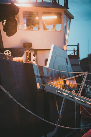 Close-up of high-tech sonar equipment glowing aboard the fishing boat during a night trip.