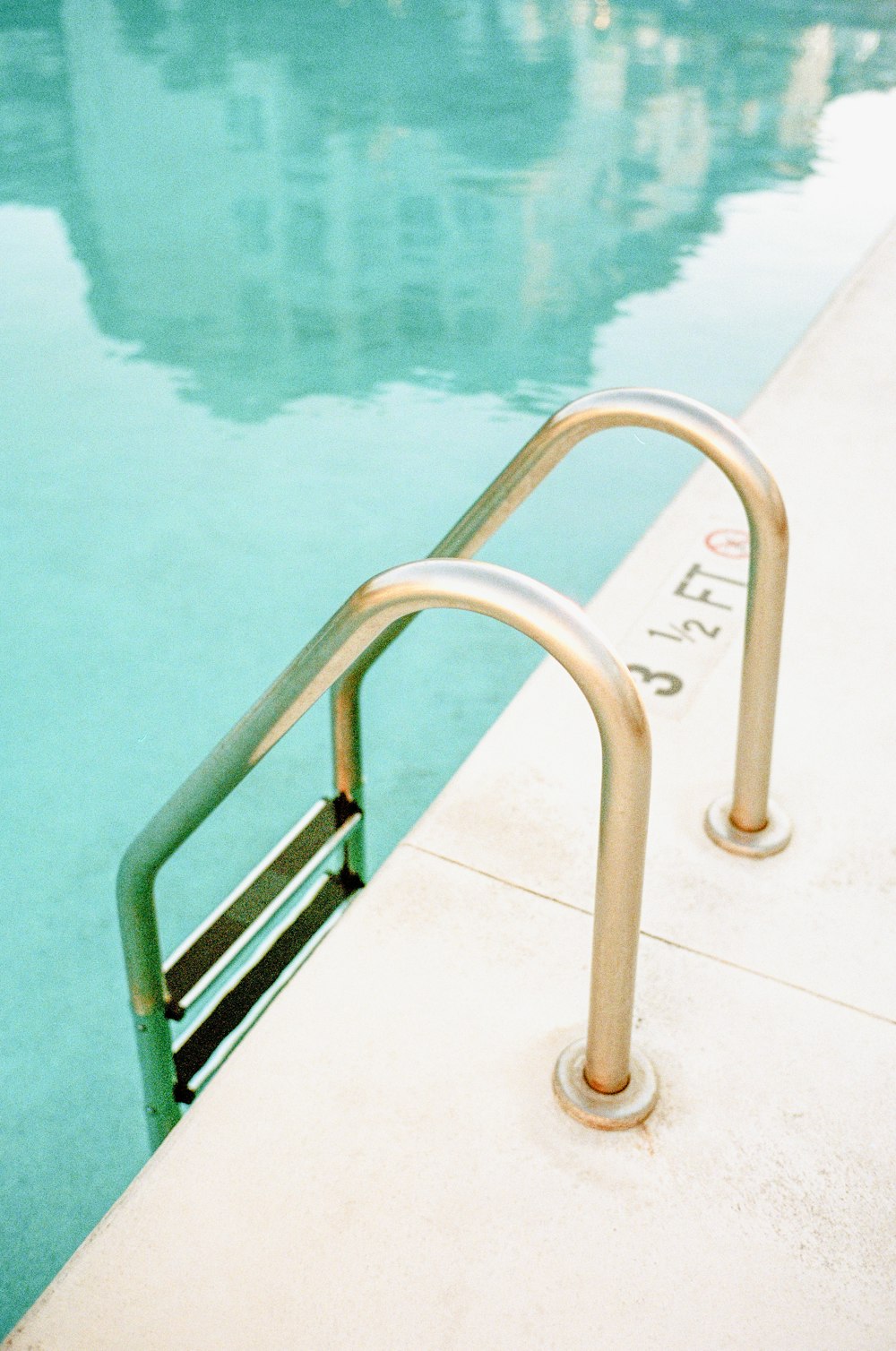white metal railings near body of water during daytime