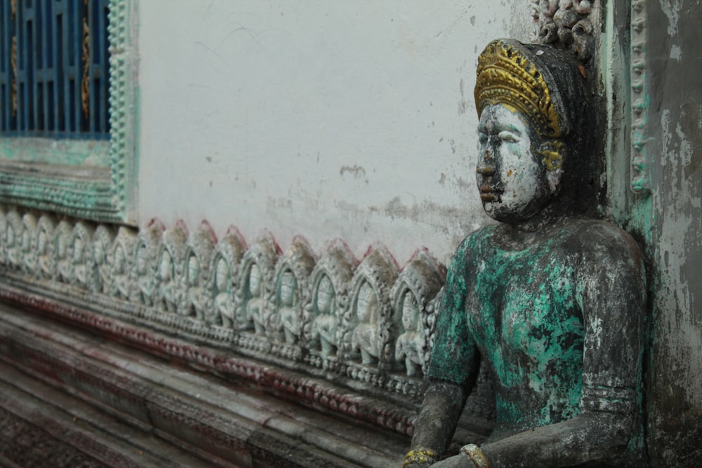 green and gold hindu deity statue