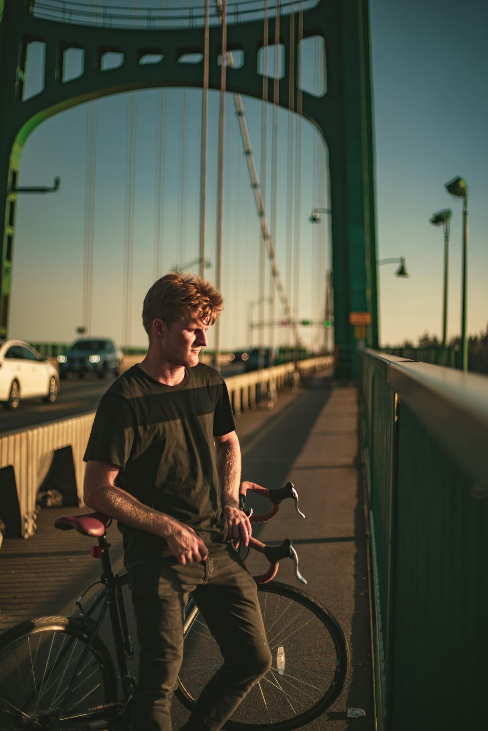 man in black t-shirt riding bicycle during daytime