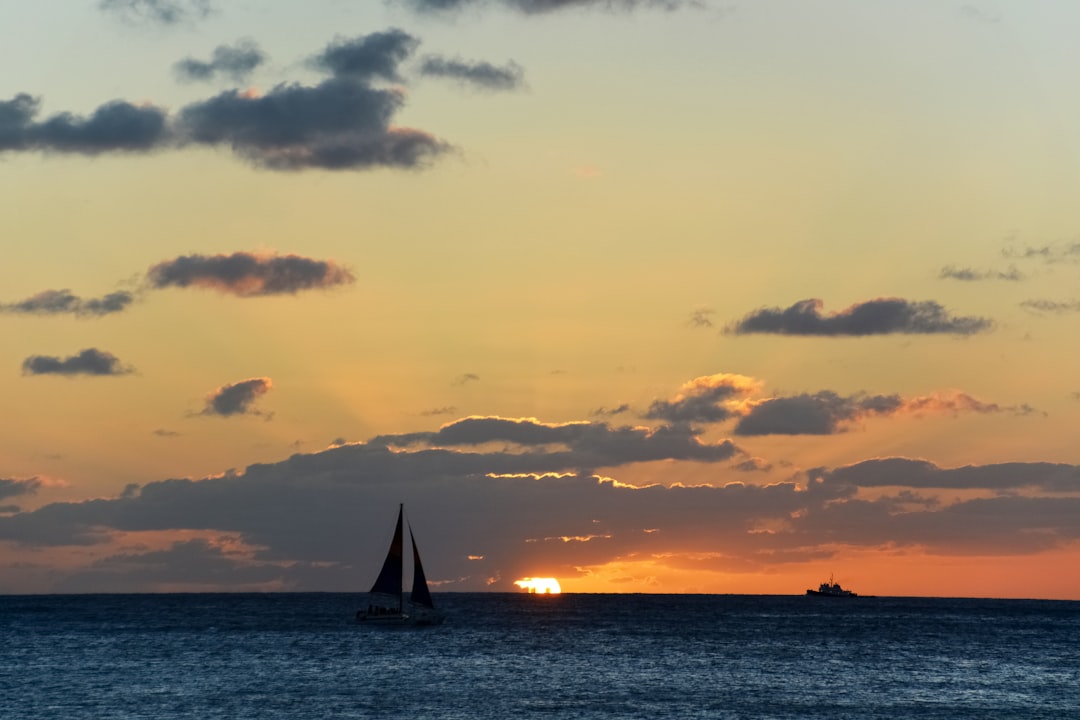 silhouette of sailboat on sea during sunset