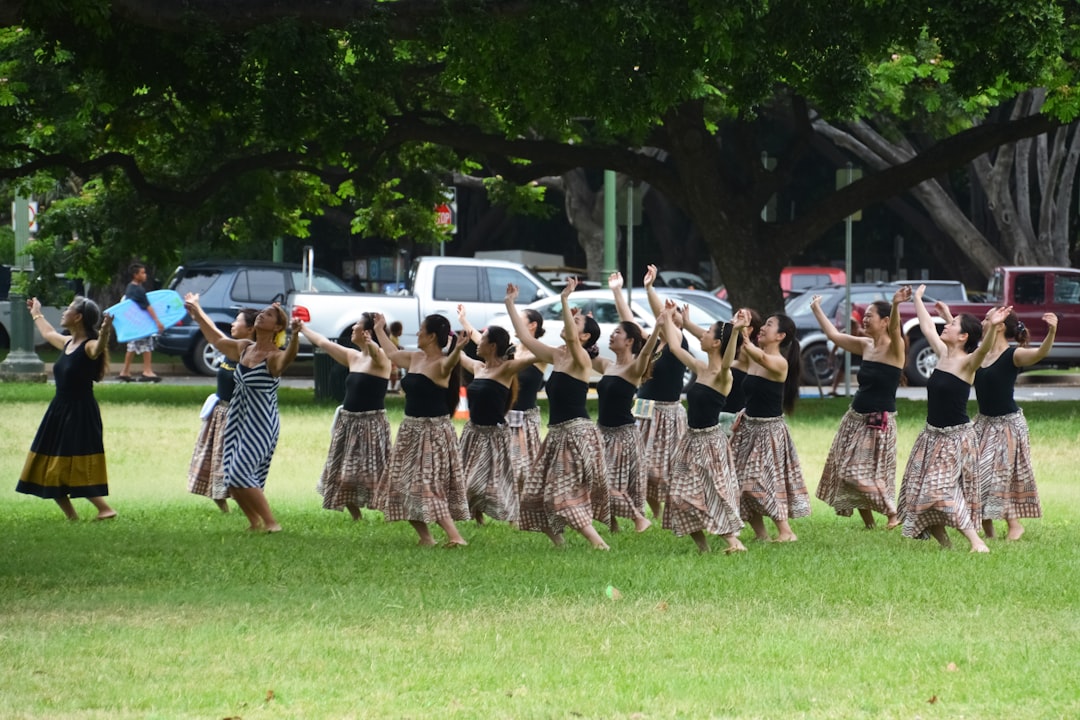 people standing on green grass field during daytime