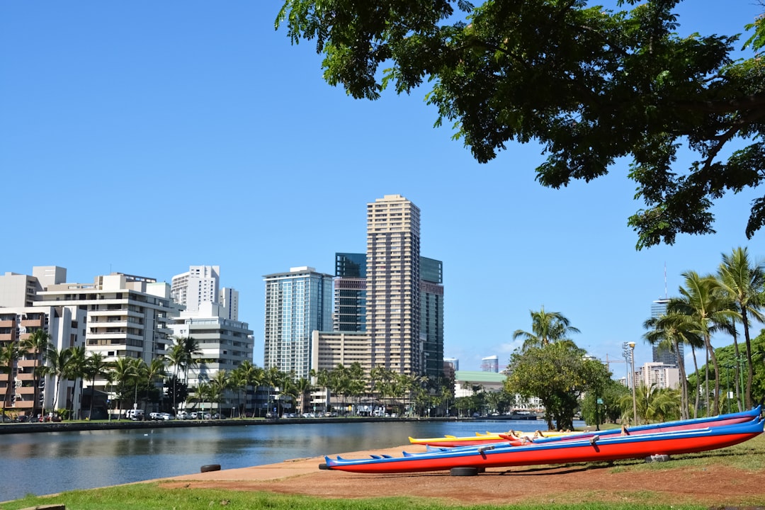 red and white boat on river near city buildings during daytime