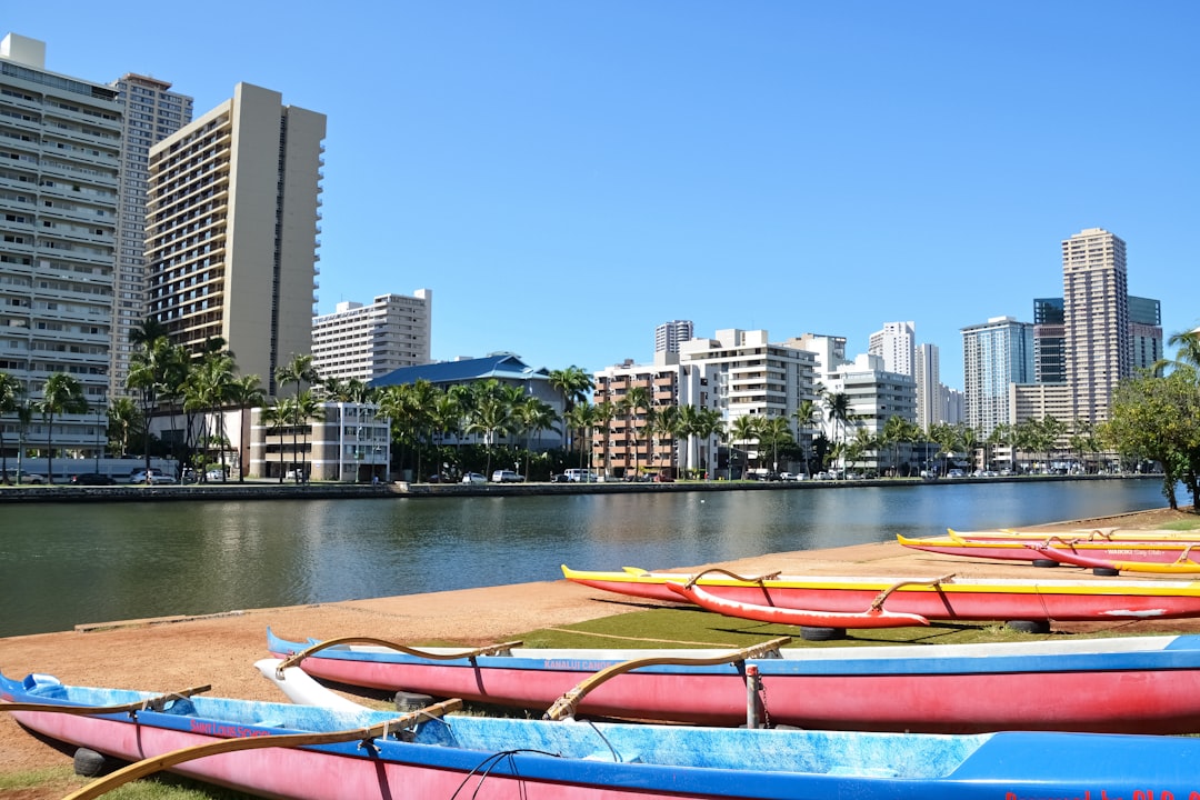 orange kayak on body of water near city buildings during daytime