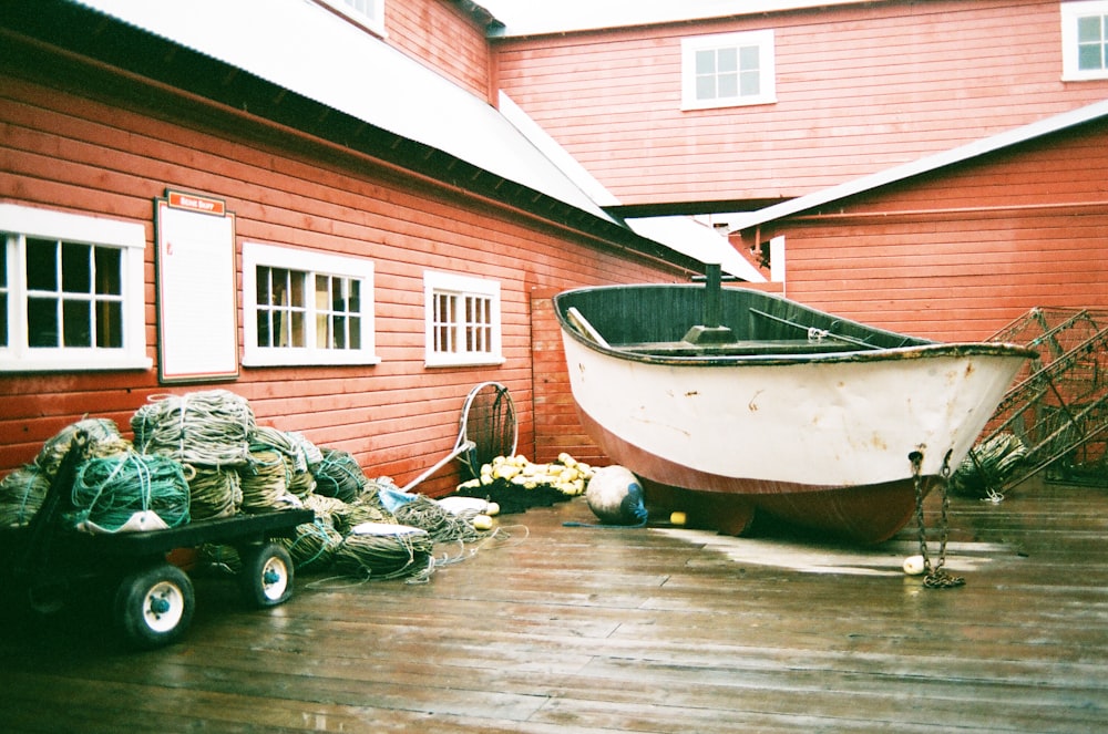 white and red boat on brown wooden floor