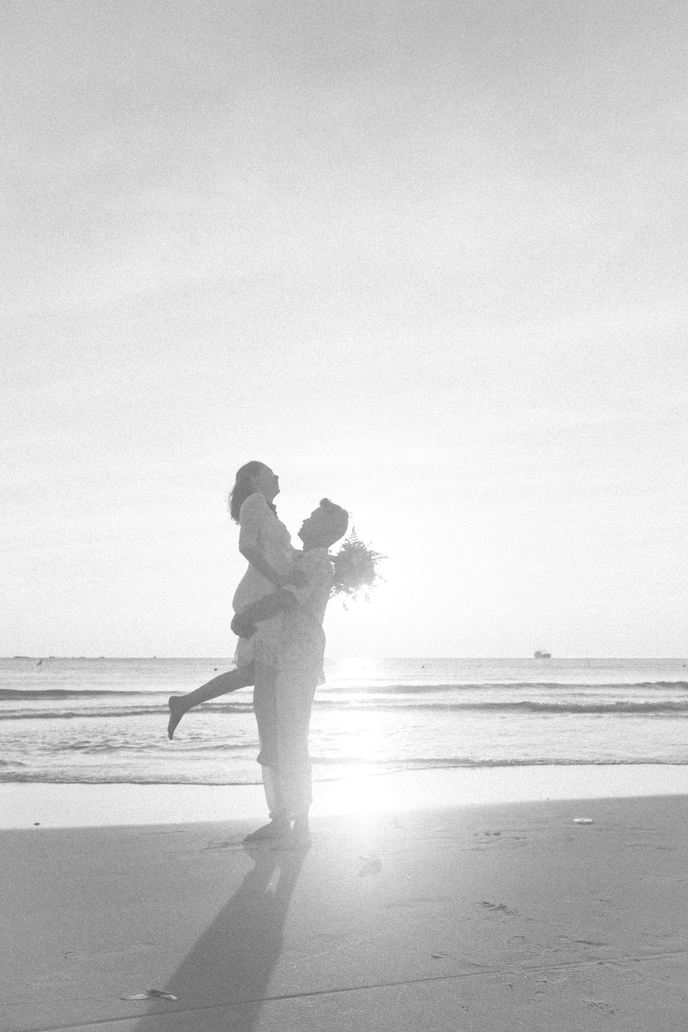 man and woman kissing on beach during daytime