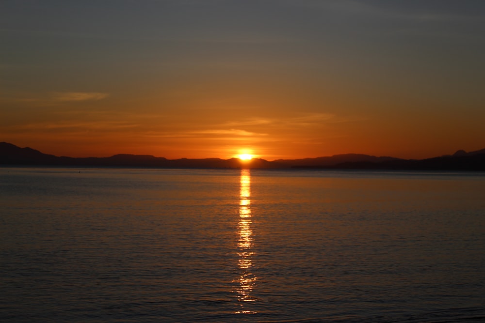 body of water during sunset