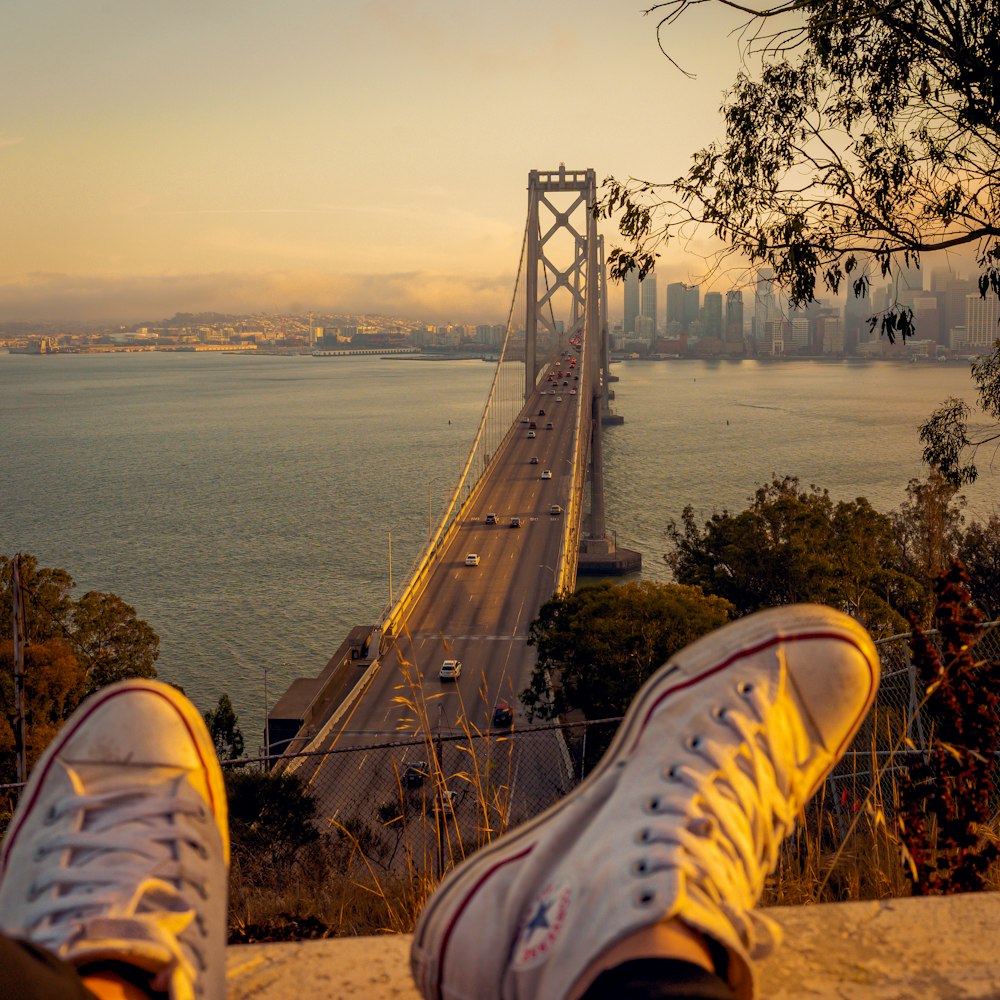 person wearing white low top sneakers