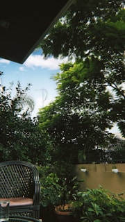 A serene outdoor patio set made from bamboo and natural fibers, surrounded by lush greenery.