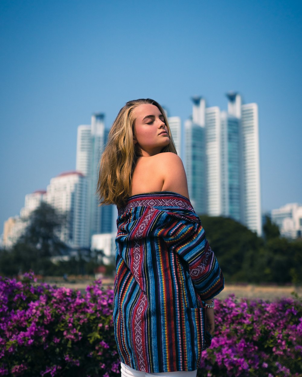 woman in black red and white off shoulder shirt standing on purple flower field during daytime