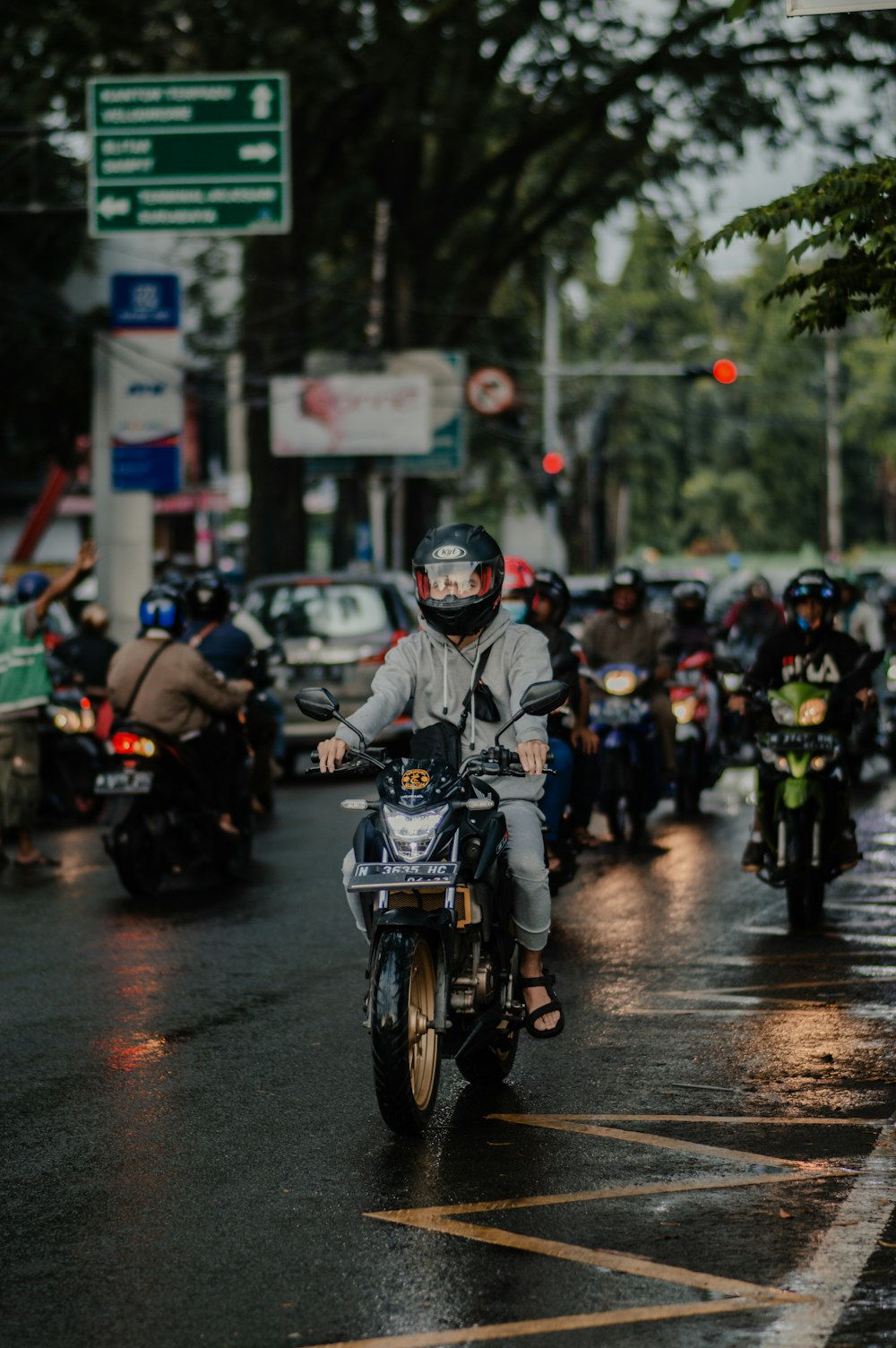 people riding motorcycle on road during daytime