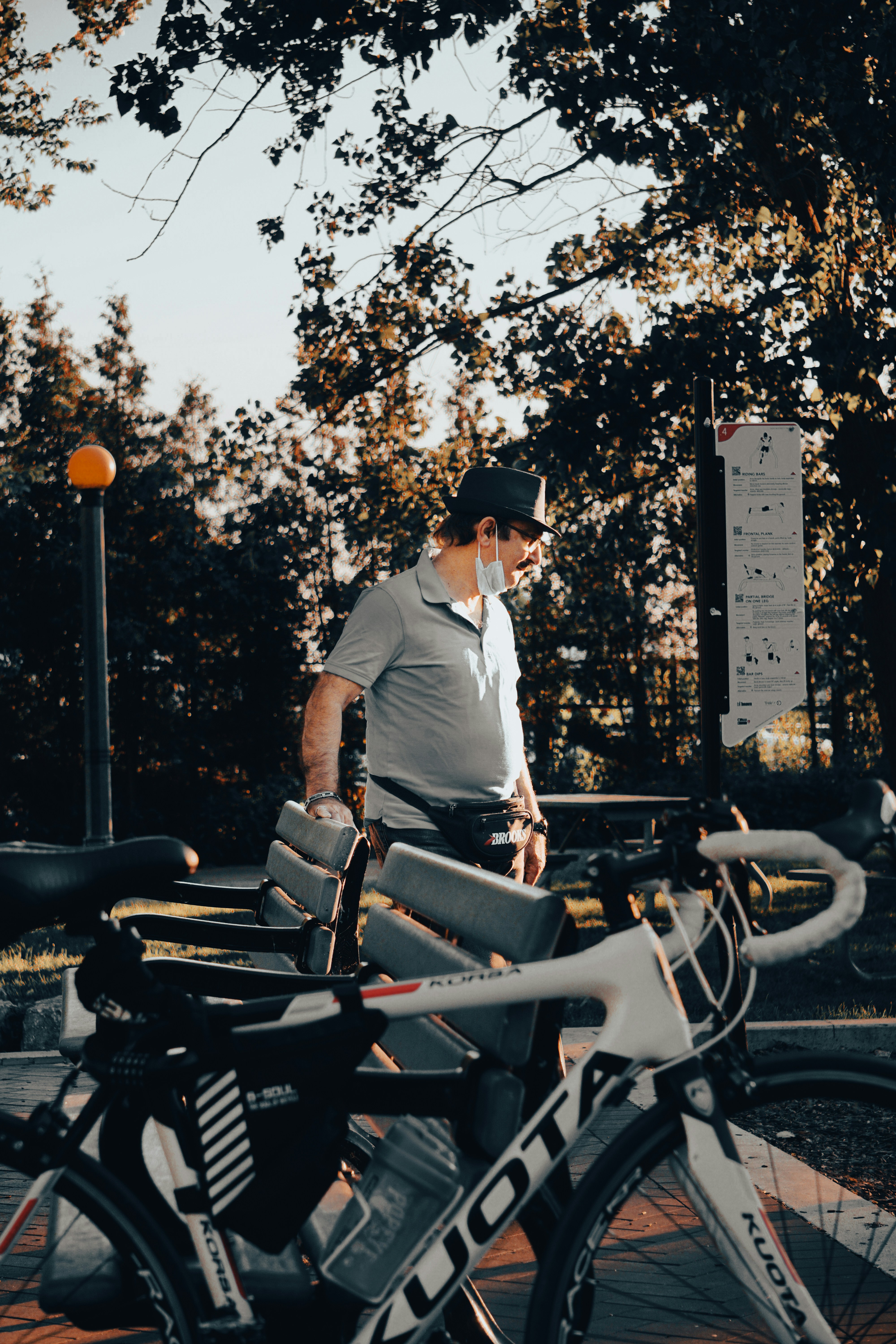 man in white shirt and black hat riding on motorcycle