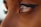 A close-up of a human eye with long eyelashes and soft lighting. The eye is well-defined, displaying detailed reflections of the surroundings. The surrounding skin appears smooth and slightly tanned.