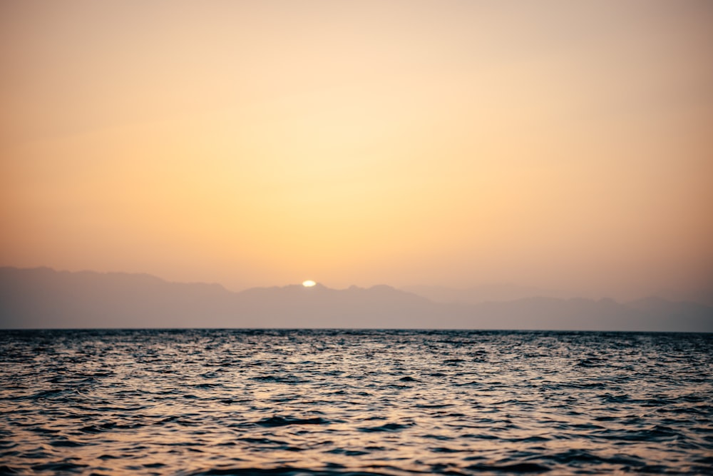 body of water during sunset