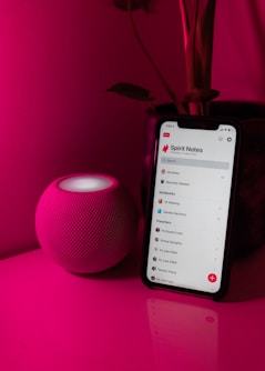 black android smartphone on pink table