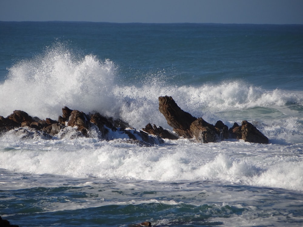 brown rock formation on sea during daytime