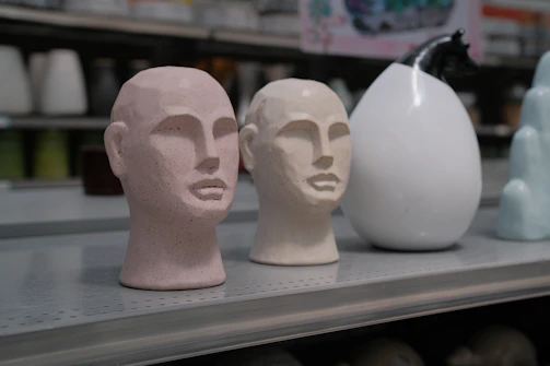 An elegant 3D portrait sculpture displayed on a minimalist shelf.