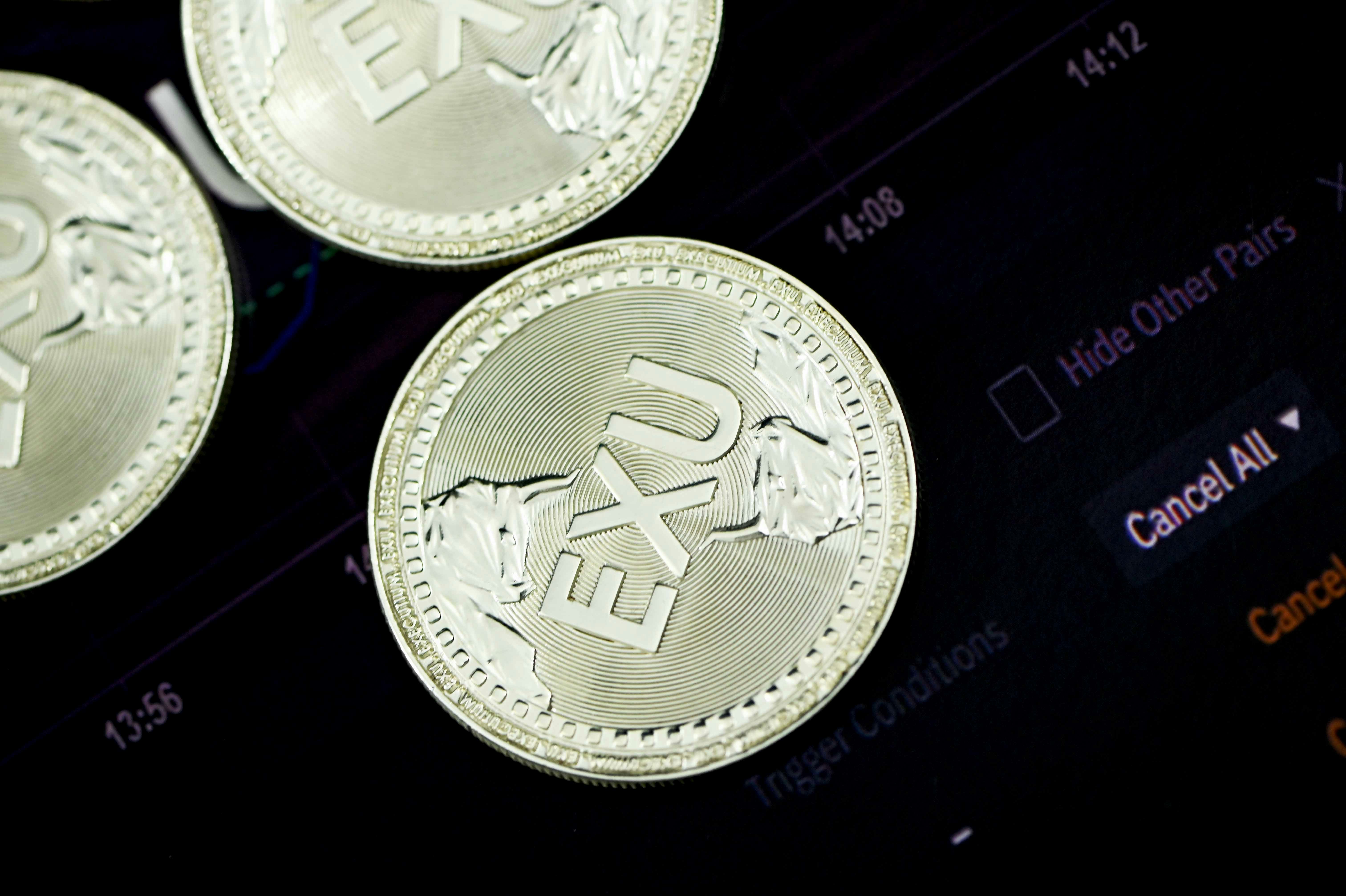 silver round coin on black surface