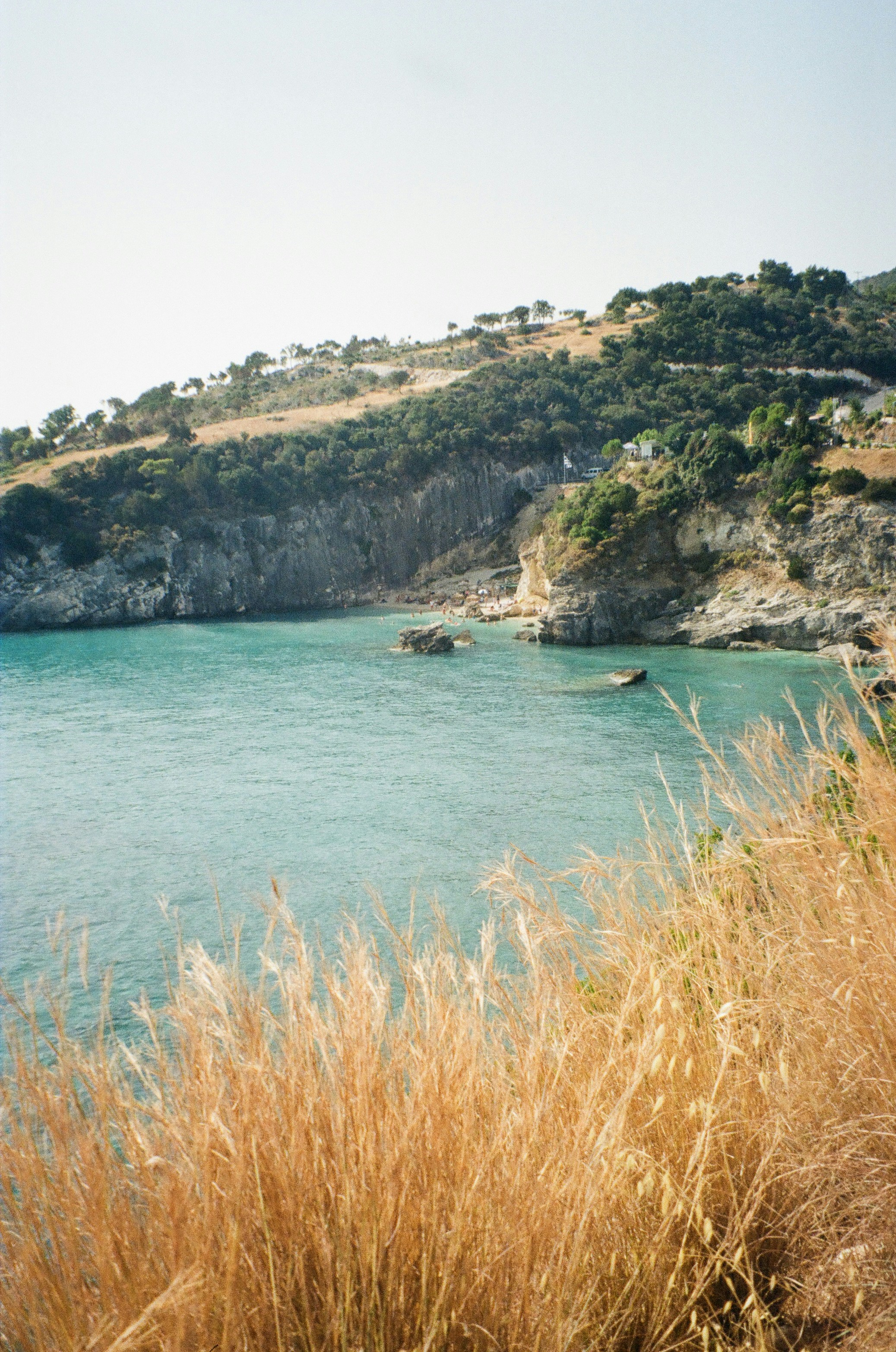 body of water near mountain during daytime