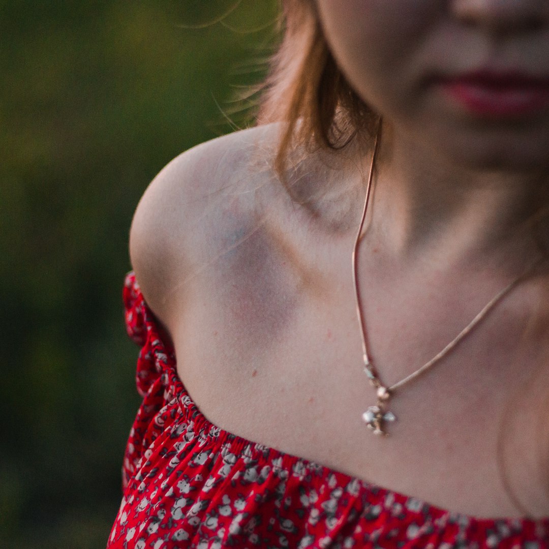 woman in red and white floral spaghetti strap top wearing silver necklace