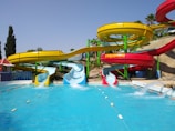 A vibrant water park with colorful slides and pools.