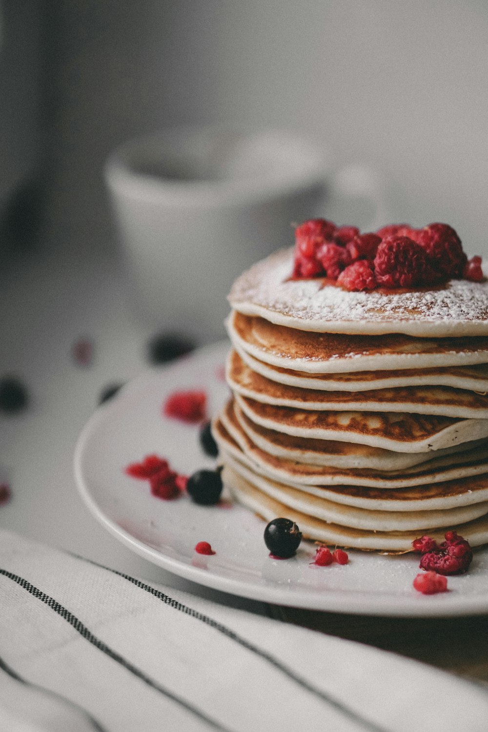 pancakes with strawberry on white ceramic plate