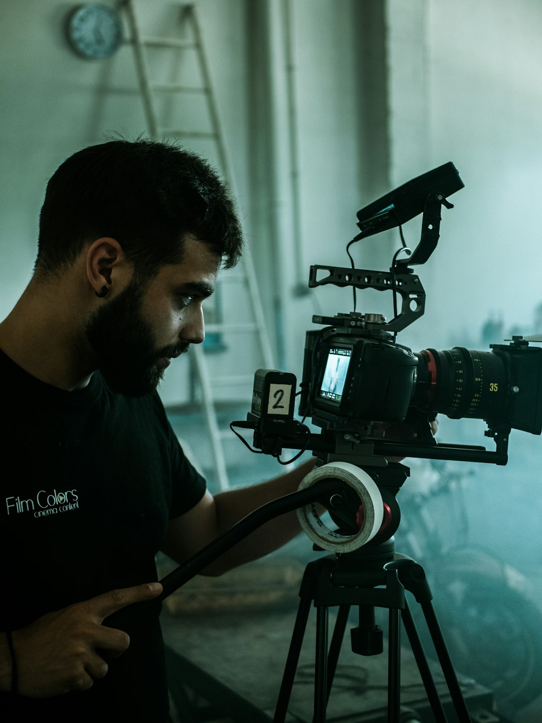 man in black crew neck t-shirt holding black dslr camera