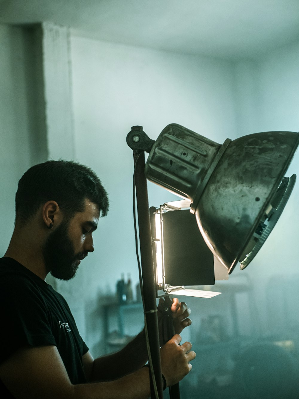 man in black shirt using black camera