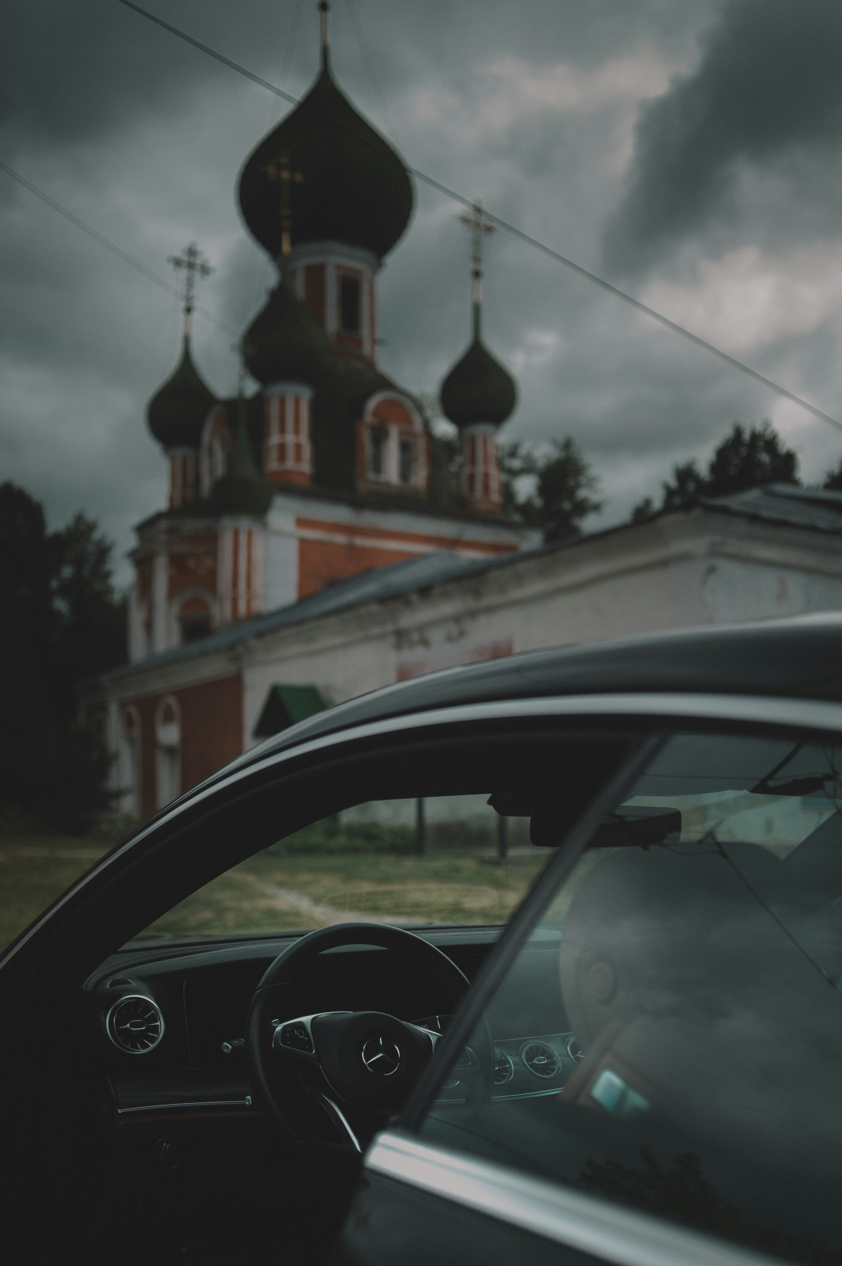 black car parked near brown building during daytime