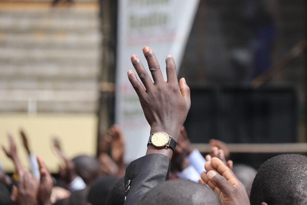 person in black suit wearing gold ring