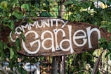 brown wooden welcome signage on green plants