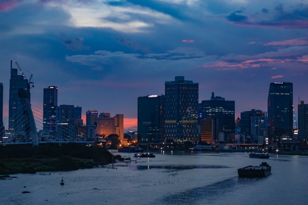 city skyline under cloudy sky during sunset